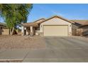 Charming single-story home featuring low maintenance desert landscaping and a neutral color palette at 1673 S 171St Dr, Goodyear, AZ 85338