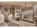 Inviting front porch with a welcome mat, decorative wreath, and a cozy seating area at 1673 S 171St Dr, Goodyear, AZ 85338