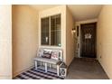Inviting front porch with cozy bench, perfect for relaxing and enjoying the neighborhood at 17937 W Westpark Blvd, Surprise, AZ 85388