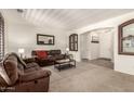 Spacious living room features plush seating, soft carpet and plenty of natural light at 17937 W Westpark Blvd, Surprise, AZ 85388