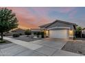 Inviting home featuring low-maintenance desert landscaping and a spacious driveway at 20858 E Sonoqui Dr, Queen Creek, AZ 85142
