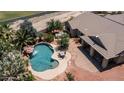 Breathtaking pool view with waterfall feature, complemented by a spa and beautiful patio area at 2101 S 167Th Dr, Goodyear, AZ 85338
