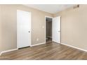 Neutral bedroom features wood-look floors, a closet, and a connecting door at 2645 W Elm St, Phoenix, AZ 85017