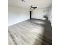 Spacious living room featuring light gray floors, neutral paint, and ample natural light at 2724 W Highland Ave, Phoenix, AZ 85017