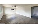 Spacious living room featuring light gray floors, neutral paint, and ample natural light at 2724 W Highland Ave, Phoenix, AZ 85017