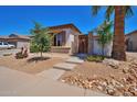 Single story home with desert landscaping featuring stone accents, a gated entry, and mature trees at 3114 E Capricorn Way, Chandler, AZ 85249