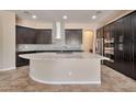 Modern kitchen featuring a large island, granite countertops, stainless steel appliances, and dark cabinets at 3114 E Capricorn Way, Chandler, AZ 85249