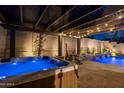 Luxurious backyard featuring a private spa, swimming pool, pergola, and outdoor fireplace at 31311 N 138Th Ave, Peoria, AZ 85383