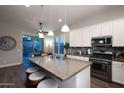 Modern kitchen with granite countertops, stainless steel appliances, and a center island at 31311 N 138Th Ave, Peoria, AZ 85383