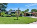 Inviting single-story home with manicured lawn, mature trees, and covered carport at 3351 N 6Th Ave, Phoenix, AZ 85013