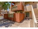 Inviting condo exterior featuring a private balcony and a stairway, and desert landscaping at 3500 N Hayden Rd # 801, Scottsdale, AZ 85251
