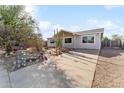 Inviting home with a well-maintained concrete driveway and desert-style landscaping with natural accents at 3508 E Gelding Dr, Phoenix, AZ 85032