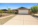 Single-story brick home with a well-maintained two-car garage and desert landscaping at 3747 W Aire Libre Ave, Phoenix, AZ 85053