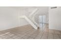Bright and airy living room with tiled floors and a staircase to the upper level at 3821 N 28Th St, Phoenix, AZ 85016