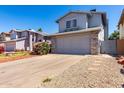 Suburban home featuring an attached garage with an extra long driveway and low maintenance landscaping at 3829 W Camino Del Rio --, Glendale, AZ 85310