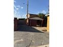 View of the property's partially constructed garage and carport showing framing and backyard access at 4418 N 19Th Pl, Phoenix, AZ 85016