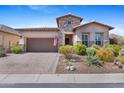Beautiful desert home with stone accents, desert landscaping, brick driveway, and a two car garage at 6948 E Quill St, Mesa, AZ 85207