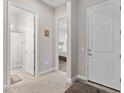 Hallway leading to the front door with views into the bathroom and bedroom at 6948 E Quill St, Mesa, AZ 85207
