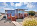 Cozy single-story home with a covered porch, well-maintained landscaping, and a charming outdoor seating area at 747 E Germann Rd # 15, San Tan Valley, AZ 85140