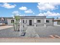 Charming home featuring a neutral-toned facade, meticulously landscaped with decorative stones and a paved walkway at 8436 N 13Th N Pl, Phoenix, AZ 85020