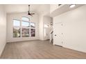 Bright living room with a vaulted ceiling, modern flooring, and a large window that brings in plenty of natural light at 8928 E Crescent Ave, Mesa, AZ 85208