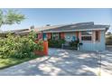Quaint single-story home featuring colorful accents and a well-kept front yard at 1027 E El Camino Dr, Phoenix, AZ 85020