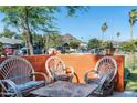Outdoor patio featuring comfortable wicker seating, an orange wall, and city views at 1027 E El Camino Dr, Phoenix, AZ 85020