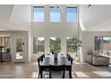 Bright and airy dining area with high ceilings, large windows, and modern decor at 10329 E Star Of The Desert Dr, Scottsdale, AZ 85255