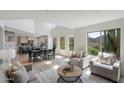 Bright open-concept living room featuring high ceilings, large windows, and modern decor at 10329 E Star Of The Desert Dr, Scottsdale, AZ 85255