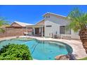 Backyard oasis showcasing a swimming pool, patio area, and lush greenery at 10951 E Delta Ave, Mesa, AZ 85208