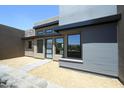 Stylish modern home with clean lines, offering a glimpse of its inviting entrance at 13290 E La Junta Rd, Scottsdale, AZ 85255