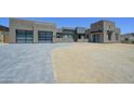 Striking modern home featuring stone accents, clean lines, and a spacious driveway at 13290 E La Junta Rd, Scottsdale, AZ 85255