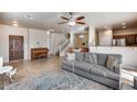 Spacious living room featuring tile floors, a ceiling fan, and a comfortable sofa at 13585 N 87Th Dr, Peoria, AZ 85381