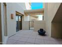 Outdoor courtyard area featuring tiled floors, a decorative pot, and access to the home's interior at 14850 E Grandview Dr # 138, Fountain Hills, AZ 85268