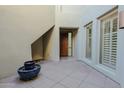 Welcoming entryway with tiled floors, a wooden front door, and a potted plant at 14850 E Grandview Dr # 138, Fountain Hills, AZ 85268