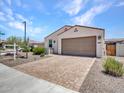 Charming single-story home with a paved driveway, well-maintained landscaping, and inviting curb appeal at 15817 S 177Th Dr, Goodyear, AZ 85338