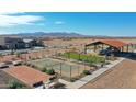 Community recreation area featuring pickle ball, bocce ball courts, picnic tables, shade structures, and playground at 17373 W Jessie Ln, Surprise, AZ 85387