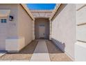 Covered entryway showcases the front door with a stone walkway and desert landscaping at 17844 W Caribbean Ln, Surprise, AZ 85388