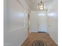 Bright foyer with decorative tile inlay and neutral paint at 17844 W Caribbean Ln, Surprise, AZ 85388