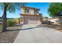 Two-story home featuring a stucco exterior, stone accents, and a long concrete driveway at 1834 W Nighthawk Way, Phoenix, AZ 85045