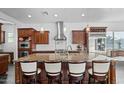 Modern kitchen featuring an island with granite countertops, stainless steel appliances, and pendant lighting at 18544 W Devonshire Ave, Goodyear, AZ 85395