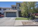 Beautiful two-story home featuring a two-car garage, manicured lawn, and mature landscaping at 18811 E Pelican Ct, Queen Creek, AZ 85142