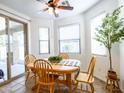Bright dining area with natural light, stylish furnishings, and access to a patio for indoor-outdoor living at 19403 E Arrowhead Trl, Queen Creek, AZ 85142