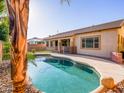 Backyard boasts a refreshing private pool, covered patio, and well-maintained landscaping, perfect for outdoor enjoyment at 19403 E Arrowhead Trl, Queen Creek, AZ 85142