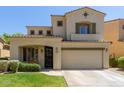 Charming two-story home with a well-maintained lawn and a two-car garage, featuring an arched entryway at 2043 W Periwinkle Way, Chandler, AZ 85248