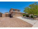 Attractive two-story home featuring neutral stucco exterior and a convenient two-car garage with extended driveway at 22196 W Tonto St, Buckeye, AZ 85326
