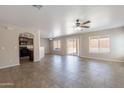 Bright, open-concept living room featuring tile flooring, ample natural light, and a smooth transition to the kitchen at 22196 W Tonto St, Buckeye, AZ 85326