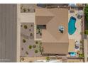 Aerial view of the property featuring a sparkling blue pool, well-maintained landscaping, and a relaxing hot tub at 2422 W Acoma Dr, Phoenix, AZ 85023