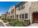 Exterior view of inviting townhomes showcasing manicured landscaping and charming architectural details at 2631 S Sulley Dr # 104, Gilbert, AZ 85295