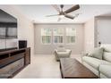 Bright living room with tile flooring, a ceiling fan, and a comfortable seating area at 2631 S Sulley Dr # 104, Gilbert, AZ 85295